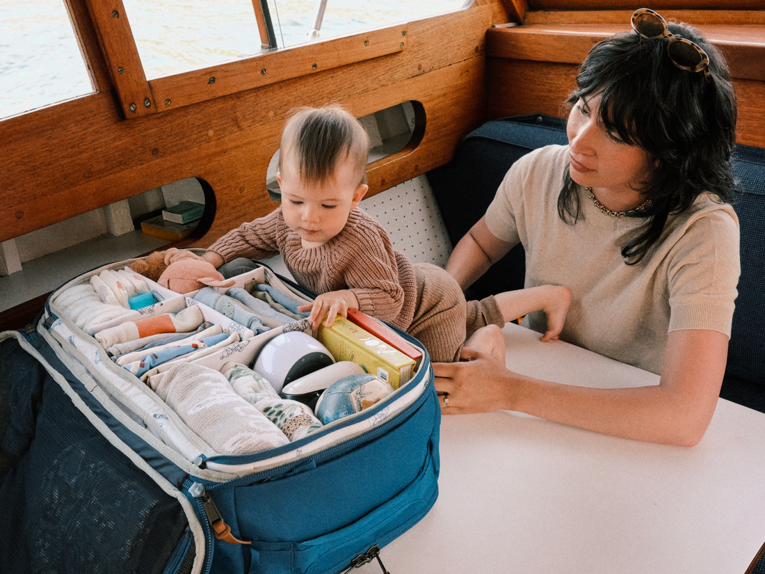 Toddler picking out items from the Hideaway Carry-On Duffel